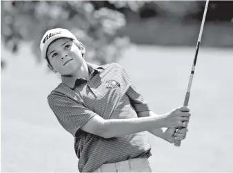  ?? STAFF PHOTOS BY ROBIN RUDD ?? Signal Mountain’s Carson Johnson watches the flight of his chip onto the 17th green. He won the District 6 Small tournament Thursday at Brown Acres Golf Course.