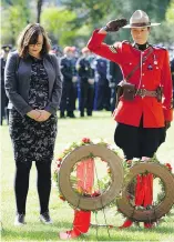  ?? LARRY WONG ?? Alberta Justice Minister and Solicitor General Kathleen Ganley, left, and RCMP Sgt. Leilani Collins pay tribute on Sunday.