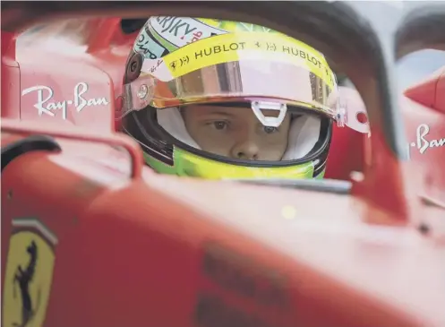  ??  ?? 0 Young driver Mick Schumacher in the cockpit of the 2019 Ferrari during a testing session at the Sakhir circuit in Bahrain.