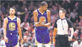  ?? AAron Ontiveroz / Denver Post via Getty Images ?? Warriors forward Kevin Durant argues a call with referee Kevin Scott as he and Stephen Curry head up court during the second half of a loss in Denver.