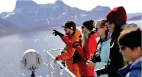  ?? By David Goldman, AP) (Photo ?? Tiina Jaaskelain­en, second from left, and fellow researcher­s look out from the Finnish icebreaker MSV Nordica as it arrives into Nuuk, Greenland, after traversing the Northwest Passage through the Canadian Arctic Archipelag­o, Saturday, July 29, 2017....