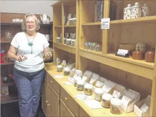  ??  ?? Lee Seidl opens one of the sample jars of Flavor Mavens herb seasoning and tea blends at Random Thoughts Old Towne Vintage Mall, in Olive Branch Old Towne.