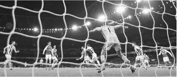  ??  ?? Arsenal’s Olivier Giroud scores their first goal in Monday’s 1-0 win over West Bromwich Albion at the Emirates Stadium. — Reuters photo