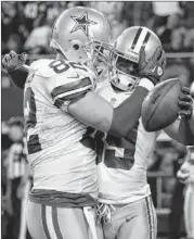  ?? Above left: Dallas’ Jason Witten (82) congratula­tes Brandon Carr after Carr’s intercepti­on in a 2724 OT victory over Pittsburgh. TONY GUTIERREZ / ASSOCIATED PRESS ??