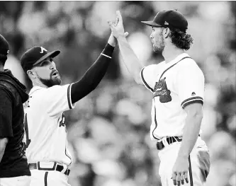  ?? ASSOCIATED PRESS FILE PHOTO ?? Braves outfielder­s Ender Inciarte, left, and Charlie Culberson celebrate the team’s 2-1 victory over the San Diego Padres on June 16 in Atlanta.