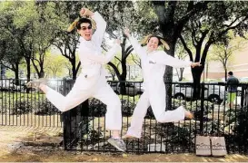  ?? Pin Lim / For the Chronicle ?? Two of Kriser’s “Poo Fairies” Robert Price and Kara Dale, jump for joy at Petapalooz­a earlier this year in Houston. The street marketing teams are armed with poop bags to give to owners to encourage them to pick up after their pets.