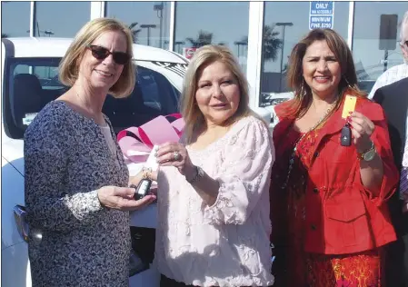  ??  ?? Rogers & Rogers Nissan owner Terri Rogers (middle) hands keys of the new vehicle to WomanHaven board president Kathy Ball (left) and WomanHaven executive director Gina Vargas. EDWIN DELGADO PHOTO