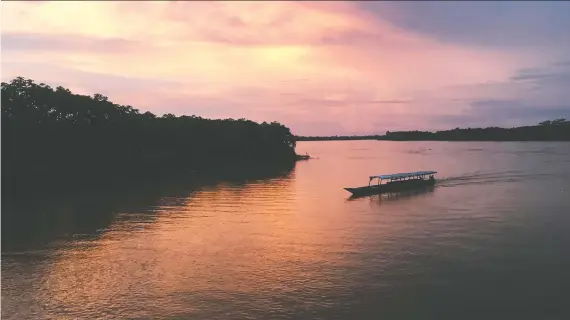  ?? PHOTOS: EMILY GILLESPIE/FOR THE WASHINGTON POST ?? A boat coasts along the Huallaga River at sunset near the town of Yurimaguas, the starting point for a trip down the Amazon.