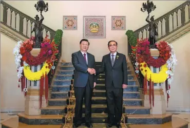  ?? ZHAI JIANLAN / XINHUA ?? Right: President Xi shakes hands with Thai Prime Minister Prayut Chan-o-cha at Government House in Bangkok on Saturday.