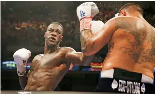  ?? AP ?? In this July 16, 2016, file photo, Deontay Wilder (left), throws a left at Chris Arreola during the WBC heavyweigh­t title bout. Wilder defends his title against Gerald Washington on Saturday. —