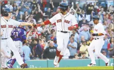  ?? Jim Rogash / Getty Images ?? Mookie Betts walks in the winning run, scored by Marco Hernandez, seen right rear, in the ninth inning against the Rangers.