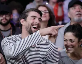  ??  ?? LOS ANGELES: In this March 21, 2017, file photo, Michael Phelps and his wife, Nicole Johnson, smile during an NBA basketball game between the Los Angeles Lakers and the Los Angeles Clippers in Los Angeles. If Phelps returns to competitiv­e swimming, the...