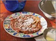  ?? PHOTO BY EMILY RYAN ?? Have a funnel and a frying pan? No need to wait for a fair or carnival. Enjoy this Pennsylvan­ia Dutch funnel cake at home.