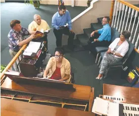  ?? STAFF PHOTOS BY JOHN RAWLSTON ?? Pianist June Edmondson helps choir members Dennis Bowman, Charlie Ramsey, Kevin Myers and Randy Lewis work on their vocal parts after choir practice at the Westside Baptist Church.