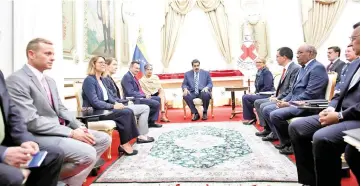  ?? — Reuters photo ?? Maduro (centre) attending a meeting with the Red Cross delegation at Miraflores Palace in Caracas,Venezuela.