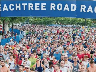  ?? BRANDEN CAMP/SPECIAL ?? The annual Atlanta Journal-Constituti­on Peachtree Road Race, which usually draws thousands of spectators on July 4, will run from Buckhead to Piedmont Park.
