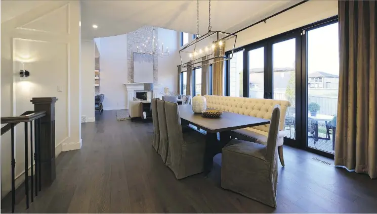  ??  ?? The dining room of the 2017 Caritas Dreamlife Lottery dream home connects the kitchen to the great room for an open-concept area adorned with hardwood floors and floor-to-ceiling windows.