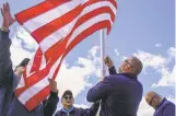  ?? CABLE HOOVER/GALLUP INDEPENDEN­T VIA AP ?? Hiroshi Miyamura, center, watches as Ken Reige, left, helps Jamie Popwell and Brantley Cargill of Flags for Vets raise a flag at Miyamura’s home May 18 in Gallup.