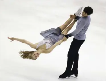  ?? WALLY SANTANA, THE ASSOCIATED PRESS ?? Kaitlyn Weaver and Andrew Poje perform in the Ice Dance Free Dance program at the Taiwan ISU Four Continents Figure Skating Championsh­ips Friday, finishing third. They expect to do better at the world’s next month in Boston.