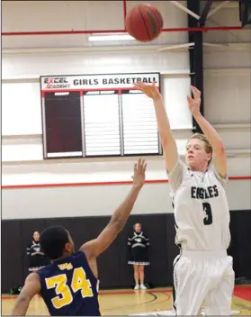  ?? COURTESY PHOTO/JERRY R. TYSON ?? Elliot Christian's Jimmy Beltz (3) launches and scores a three-point basket against a Western Sierra defender during last season's playoffs.