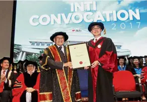  ??  ?? Reward for excellence: Arshad (left) awarding Liew with the Honorary Doctorate of Entreprene­urship.