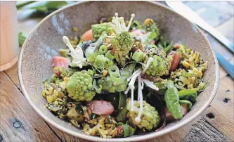  ?? LIDA LADWIG ?? At Cafe de Ceuvel in Amsterdam, the “Colourful Cauliflowe­r Salad” includes cauliflowe­r florets, Romanesco broccoli, fresh green herbs, strips of tangy caramelize­d rhubarb and locally sourced goat cheese.