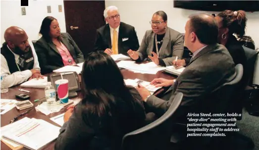  ??  ?? Airica Steed, center, holds a “deep dive” meeting with patient engagement and hospitalit­y staff to address patient complaints.