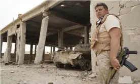  ??  ?? A Russian soldier stands in front of a destroyed tank factory operated by Isis militants. Photograph: Nataliya Vasilyeva/AP