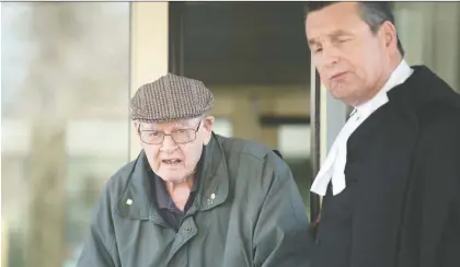  ?? TROY FLEECE ?? Father Robert Mackenzie, who denies the allegation­s against him, leaves court with his lawyer Al Mcintyre in Regina on Wednesday.