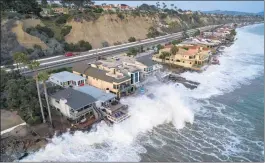  ?? FILE: JEFF GRITCHEN — STAFF PHOTOGRAPH­ER ?? Homes along Capistrano Beach get pelted with waves during high tide in Dana Point in August.