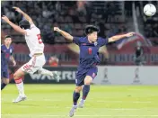  ?? WICHAN CHAROENKIA­TPAKUL ?? RIGHT Thailand’s Ekanit Panya, right, plays against the UAE in a World Cup qualifier.