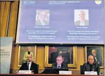  ?? AP PHOTO ?? The laureates of the Nobel Prize in Economics displayed on the screen, William Nordhaus, left, and Paul Romer during a press conference at the The Royal Swedish Academy of Sciences in Stockholm, Monday.