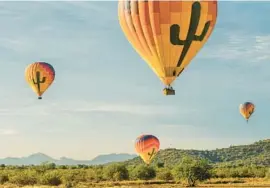  ?? KEN MOINESTER ?? Launching from Deer Valley Airport in Phoenix, Hot Air Expedition­s offers daily private and shared flights — at sunrise and sunset — aboard hot air balloons.