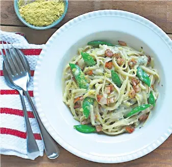  ??  ?? This creamy-style, gluten-free pasta dish is rich and flavourful, despite containing no dairy products. Nutritiona­l yeast flakes give the pasta sauce a cheese-like taste.