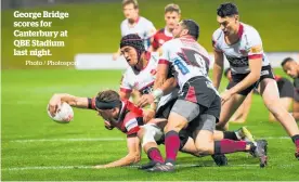  ?? Photo / Photosport ?? George Bridge scores for Canterbury at QBE Stadium last night.