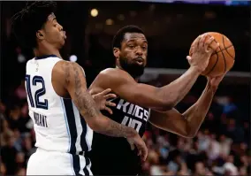  ?? AP PHOTO BY NIKKI BOERTMAN ?? In this Feb. 28 file photo, Sacramento Kings forward Harrison Barnes (40) looks to pass while defended by Memphis Grizzlies guard Ja Morant (12) during the first half of an NBA basketball game in Memphis, Tenn. Harrison Barnes became the latest NBA player to reveal that he has coronaviru­s, making the announceme­nt Tuesday, July 14, and saying he has hopes to join his team at the league’s restart later this summer.