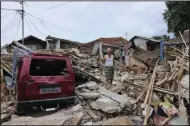  ?? (AP/Rangga Firmansyah) ?? A man walks Friday in the rubble of a neighborho­od heavily affected by Monday’s earthquake, in Cianjur, West Java, Indonesia.
