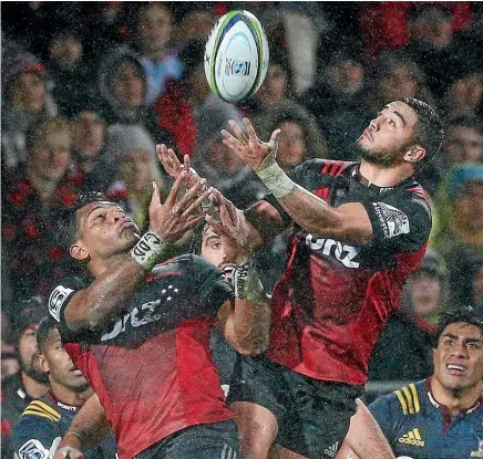  ??  ?? Seta Tamanivalu and Bryn Hall leap high to grab the ball for the Crusaders.