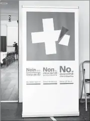  ?? PETER SCHNEIDER/AP ?? A poster from the committee against EU gun laws and policies is seen Sunday in Burgdorf, Switzerlan­d.