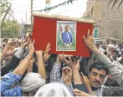  ?? YAHYA ARHAB, EPA Yemeni mourners carry the coffin of Bashar Arhab, one of the victims of suicide attacks targeting mosques, in Sanaa onMonday. ??