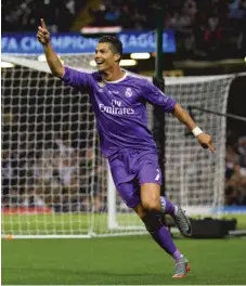  ??  ?? Cristiano Ronaldo celebrates after scoring the second of his two goals Saturday against Juventus in the Champions League final.
| GETTY IMAGES