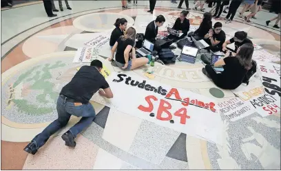  ?? [ERIC GAY/THE ASSOCIATED PRESS] ?? “Sanctuary city” legislatio­n is not just a federal issue. Students gathered Wednesday in the rotunda at the Texas Capitol to oppose Senate Bill 4, an anti-sanctuary cities bill that has cleared the Texas Senate and seeks to jail sheriffs and other...