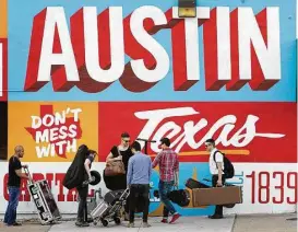  ?? Jay Janner / AP ?? FILE - In this March 14, 2013 file photo, a band is on the move on the corner of Sixth Street and I-35 at South by Southwest in Austin, Texas. iTunes is putting its stamp on South by Southwest, piggybacki­ng on the annual event hosted by the city of...