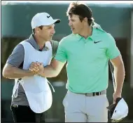  ?? AP/CHARLIE RIEDEL ?? Brooks Koepka is congratula­ted by caddie Ricky Elliott after finishing the fourth round Sunday at the U.S. Open in Erin, Wis.