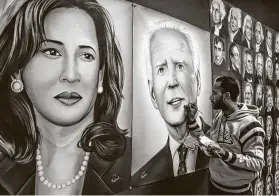  ?? Narinder Nanu / AFP via Getty Images ?? Jag jot Singh Rubal puts the final touches to a painting depicting Joe Biden and Kamala Harris on Tuesday in the northweste­rn city of Amritsar, India.