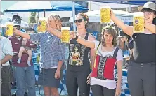  ?? STAFF FILE PHOTO ?? Women vie in the beer stein-holding competitio­n during the Oktoberfes­t celebratio­n Sept. 23 at the Speisekamm­er restaurant in Alameda.