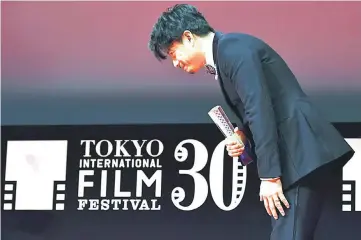  ?? — AFP photo ?? Duan at the end of a speech after receiving the Best Actor award for his movie ‘The Looming Storm’.