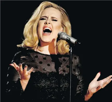  ?? ASSOCIATED PRESS FILES ?? British singer Adele’s highly anticipate­d new album, with its poignant reflection­s on life and love, is in stores now.