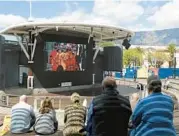  ?? NARDUS ENGELBRECH­T/AP ?? People watch the queen’s funeral live on a big screen Monday in Cape Town, South Africa.