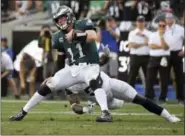  ?? MARK J. TERRILL — THE ASSOCIATED PRESS ?? Philadelph­ia Eagles quarterbac­k Carson Wentz, right, is tackled by Los Angeles Rams linebacker Samson Ebukam during the second half of an NFL football game Sunday in Los Angeles.